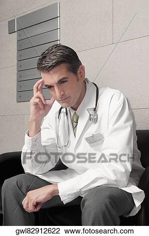 Doctor sitting on a chair and thinking View Large Photo Image Stock Image - Doctor sitting on a chair and thinking. Fotosearch