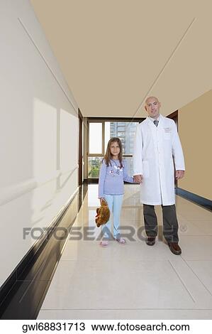 Doctor standing with a girl View Large Photo Image Stock Image - Doctor standing with a girl. Fotosearch