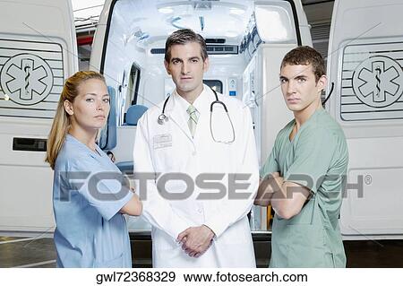 Doctor standing with nurses View Large Photo Image Stock Photo - Doctor standing with nurses. Fotosearch
