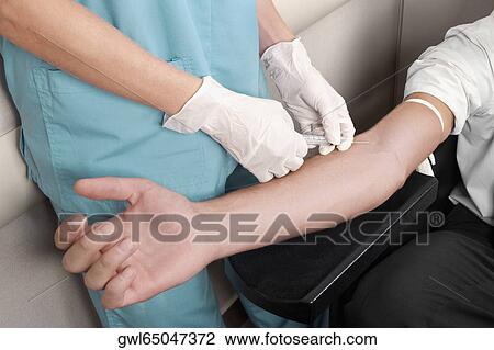 Doctor taking blood sample of a patient View Large Photo Image Stock Image - Doctor taking blood sample of a patient. Fotosearch