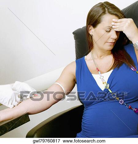Stock Photo - Doctor taking blood sample of a pregnant woman. Fotosearch