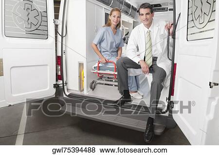 Stock Photo - Doctor with a female nurse in an ambulance. Fotosearch