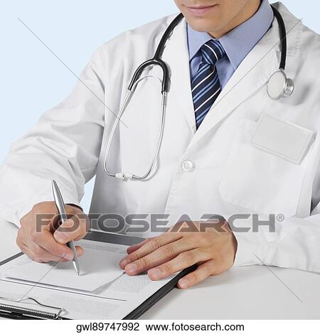 Doctor writing on a clipboard View Large Photo Image Stock Image - Doctor writing on a clipboard. Fotosearch