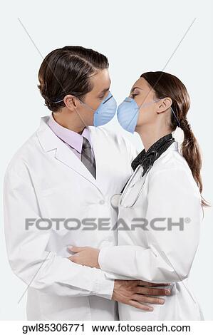 Doctors wearing flu masks and romancing View Large Photo Image Stock Image - Doctors wearing flu masks and romancing. Fotosearch