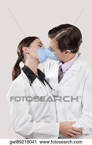 Doctors wearing flu masks and romancing View Large Photo Image Stock Image - Doctors wearing flu masks and romancing. Fotosearch