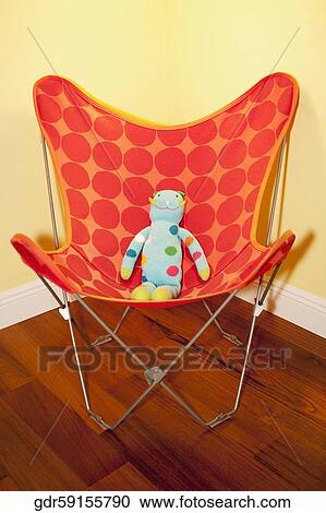 Stock Image - Doll in a chair. Fotosearch