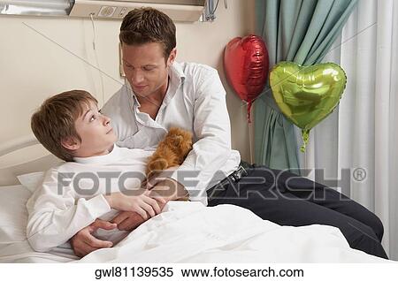 Father with his son in a hospital View Large Photo Image Stock Photography - Father with his son in a hospital. Fotosearch