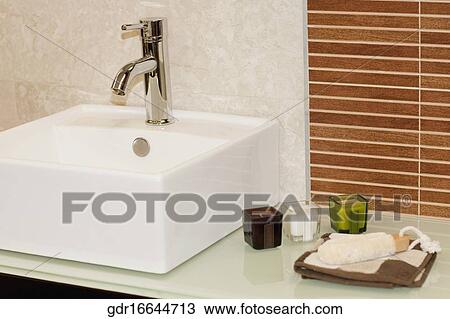 Faucet with toiletries in the bathroom View Large Photo Image Stock Image - Faucet with toiletries in the bathroom. Fotosearch