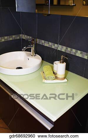 Faucet with toiletries in the bathroom View Large Photo Image Stock Image - Faucet with toiletries in the bathroom. Fotosearch