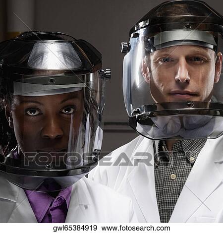Female and a male doctor wearing protective gears in a laboratory View Large Photo Image Stock Photo - Female and a male doctor wearing protective gears in a laboratory. Fotosearch
