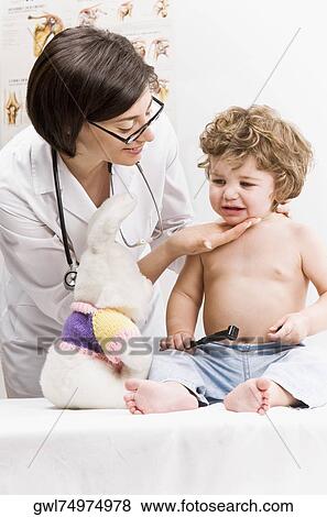 Stock Photo - Female doctor consoling a baby boy. Fotosearch