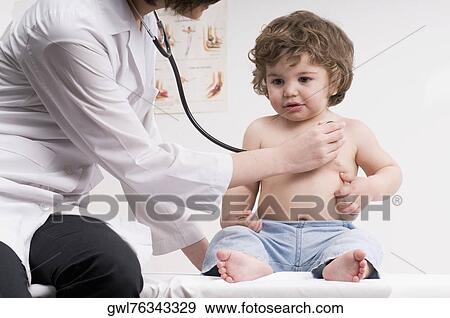 Female doctor examining a baby boy with a stethoscope View Large Photo Image Stock Photo - Female doctor examining a baby boy with a stethoscope. Fotosearch
