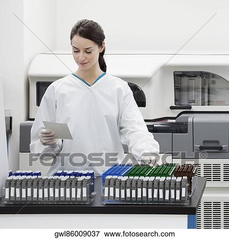 Female doctor examining a report in a laboratory View Large Photo Image Stock Photo - Female doctor examining a report in a laboratory. Fotosearch