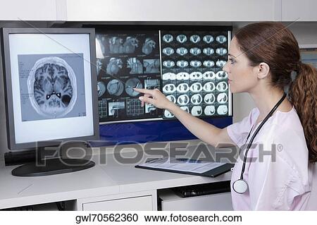 Female doctor examining MRI report View Large Photo Image Stock Image - Female doctor examining MRI report. Fotosearch