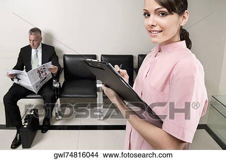 Female doctor holding a clipboard View Large Photo Image Picture - Female doctor holding a clipboard. Fotosearch