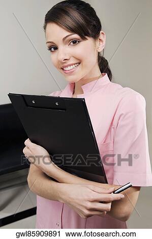Female doctor holding a clipboard View Large Photo Image Stock Image - Female doctor holding a clipboard. Fotosearch