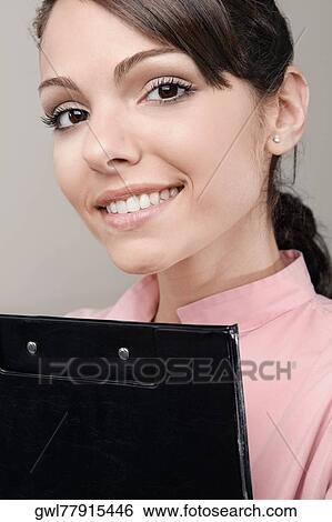 Female doctor holding a clipboard View Large Photo Image Stock Photograph - Female doctor holding a clipboard. Fotosearch