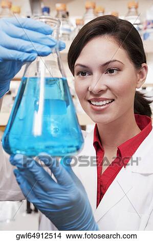 Female doctor holding a conical flask in a laboratory View Large Photo Image Picture - Female doctor holding a conical flask in a laboratory. Fotosearch