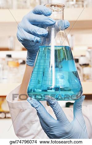 Female doctor holding a conical flask in a laboratory View Large Photo Image Picture - Female doctor holding a conical flask in a laboratory. Fotosearch
