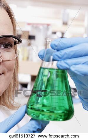 Female doctor holding a conical flask in a laboratory View Large Photo Image Stock Photo - Female doctor holding a conical flask in a laboratory. Fotosearch