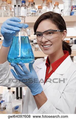 Female doctor holding a conical flask in a laboratory View Large Photo Image Stock Photo - Female doctor holding a conical flask in a laboratory. Fotosearch