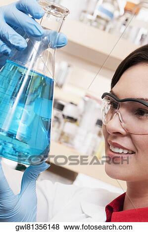 Female doctor holding a conical flask in a laboratory View Large Photo Image Stock Photo - Female doctor holding a conical flask in a laboratory. Fotosearch