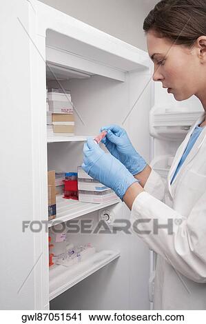 Female doctor holding a medical sample in a laboratory View Large Photo Image Stock Image - Female doctor holding a medical sample in a laboratory. Fotosearch