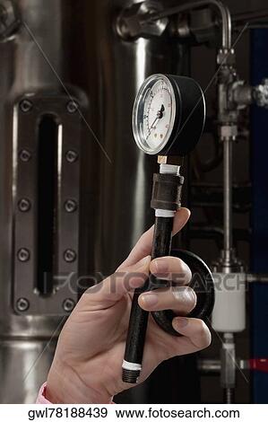 Female doctor holding a pressure gauge in a laboratory View Large Photo Image Stock Photo - Female doctor holding a pressure gauge in a laboratory. Fotosearch
