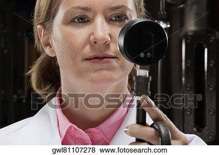 Female doctor holding a pressure gauge in a laboratory View Large Photo Image Stock Photo - Female doctor holding a pressure gauge in a laboratory. Fotosearch