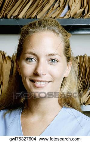 Picture - Female doctor in a record room. Fotosearch