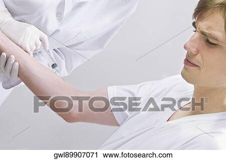 Female doctor injecting on a patient's arm View Large Photo Image Stock Image - Female doctor injecting on a patient's arm. Fotosearch