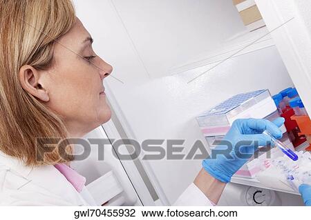 Stock Image - Female doctor researching in a laboratory. Fotosearch