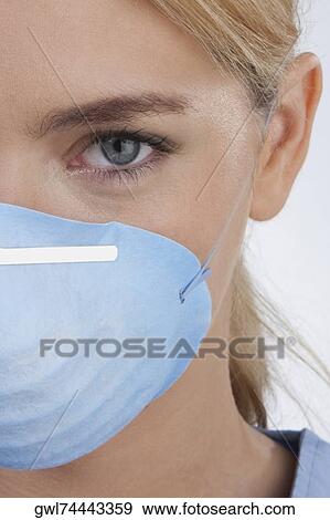 Female doctor wearing a flu mask View Large Photo Image Stock Photo - Female doctor wearing a flu mask. Fotosearch