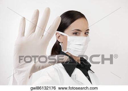 Stock Photograph - Female doctor wearing a flu mask. Fotosearch