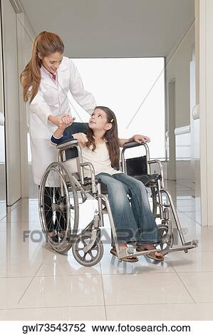 Female doctor with a patient in a wheelchair View Large Photo Image Stock Image - Female doctor with a patient in a wheelchair. Fotosearch