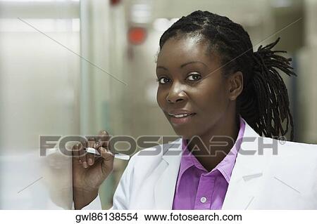 Female doctor writing on a whiteboard in a hospital View Large Photo Image Picture - Female doctor writing on a whiteboard in a hospital. Fotosearch