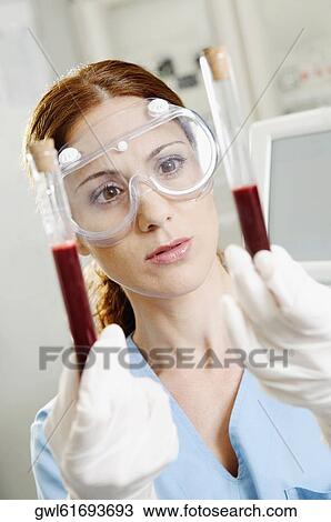 Female lab technician holding blood samples in test tubes View Large Photo Image Stock Image - Female lab technician holding blood samples in test tubes. Fotosearch