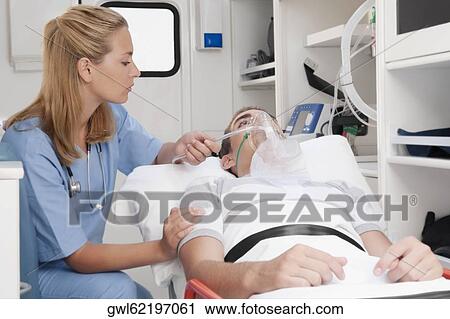 Female nurse assisting a patient in an ambulance View Large Photo Image Stock Image - Female nurse assisting a patient in an ambulance. Fotosearch