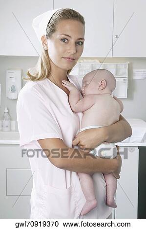 Female nurse carrying a newborn baby View Large Photo Image Stock Image - Female nurse carrying a newborn baby. Fotosearch