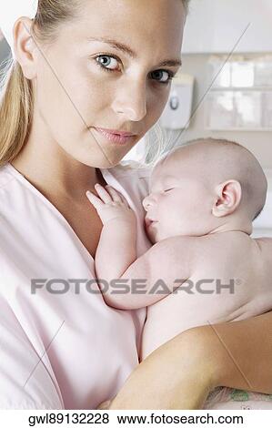 Female nurse carrying a newborn baby View Large Photo Image Stock Photo - Female nurse carrying a newborn baby. Fotosearch