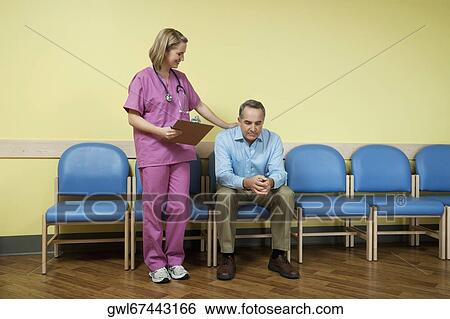 Female nurse consoling a patient in the waiting room View Large Photo Image Stock Photograph - Female nurse consoling a patient in the waiting room. Fotosearch