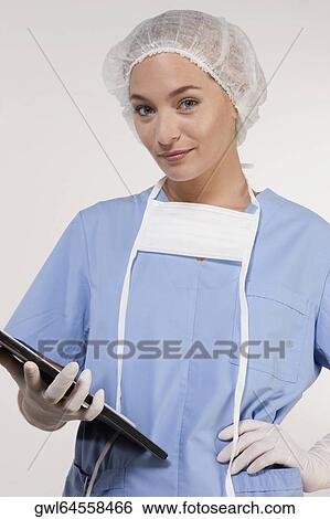 Female nurse holding a clipboard View Large Photo Image Stock Photograph - Female nurse holding a clipboard. Fotosearch