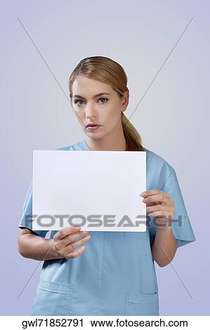Female nurse holding blank placard View Large Photo Image Stock Image - Female nurse holding blank placard. Fotosearch