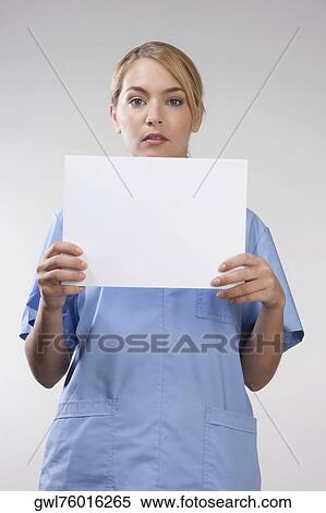 Female nurse holding blank placard View Large Photo Image Stock Photography - Female nurse holding blank placard. Fotosearch