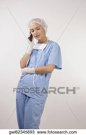 Female nurse talking on a mobile phone View Large Photo Image Stock Image - Female nurse talking on a mobile phone. Fotosearch