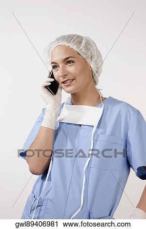 Female nurse talking on a mobile phone View Large Photo Image Stock Image - Female nurse talking on a mobile phone. Fotosearch