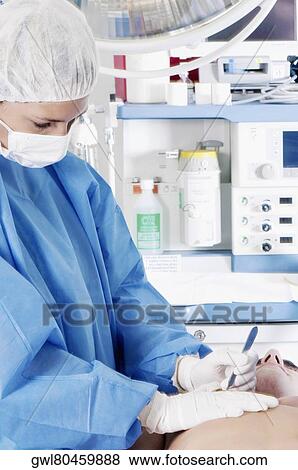 Female surgeon performing surgery View Large Photo Image Stock Photo - Female surgeon performing surgery. Fotosearch