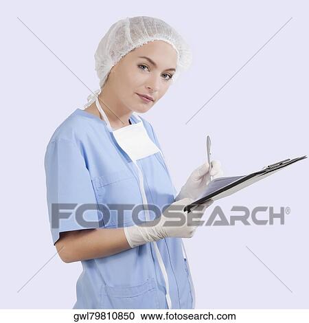 Female surgeon writing on a clipboard View Large Photo Image Stock Image - Female surgeon writing on a clipboard. Fotosearch