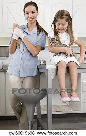 Female vet with a girl carrying cats View Large Photo Image Stock Photo - Female vet with a girl carrying cats. Fotosearch
