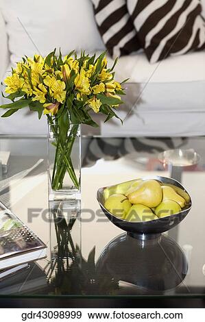 Stock Photo - Flower vase and a bowl of artificial pears on a table. Fotosearch